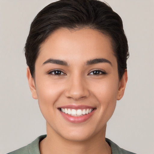 Joyful white young-adult female with short  brown hair and brown eyes