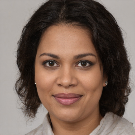 Joyful black young-adult female with medium  brown hair and brown eyes