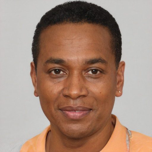 Joyful latino adult male with short  black hair and brown eyes