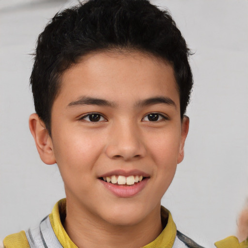 Joyful latino child male with short  brown hair and brown eyes