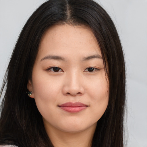 Joyful asian young-adult female with long  brown hair and brown eyes