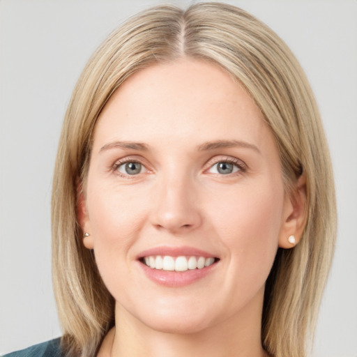 Joyful white young-adult female with medium  brown hair and blue eyes