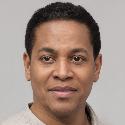 Joyful latino adult male with short  black hair and brown eyes