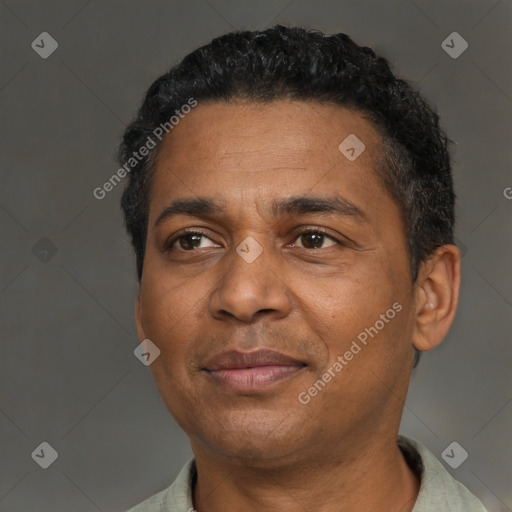 Joyful black adult male with short  black hair and brown eyes