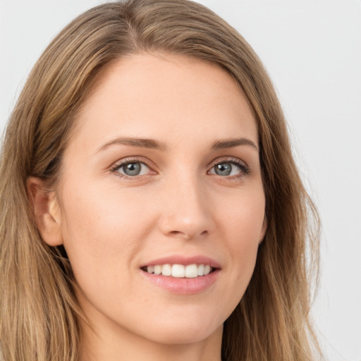 Joyful white young-adult female with long  brown hair and green eyes