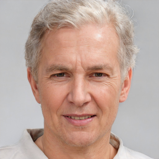 Joyful white middle-aged male with short  gray hair and brown eyes