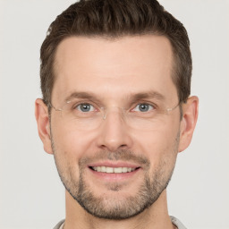 Joyful white adult male with short  brown hair and grey eyes