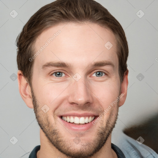 Joyful white young-adult male with short  brown hair and grey eyes