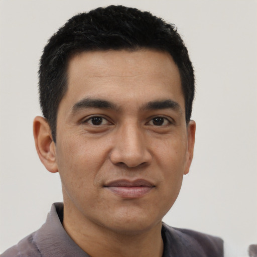 Joyful asian young-adult male with short  black hair and brown eyes