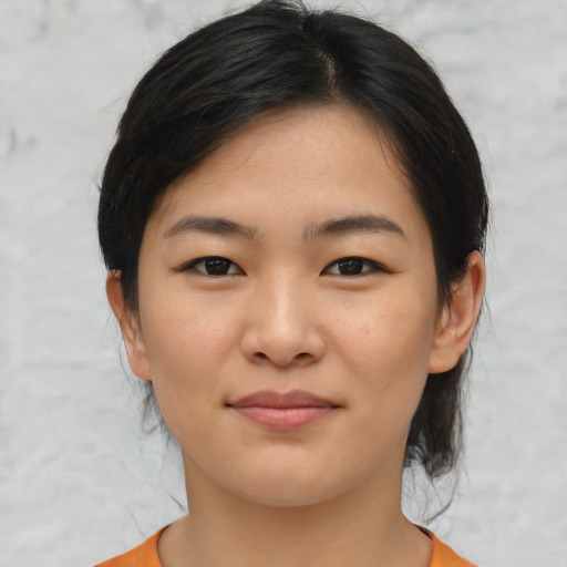 Joyful asian young-adult female with medium  black hair and brown eyes