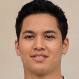 Joyful latino young-adult male with short  brown hair and brown eyes