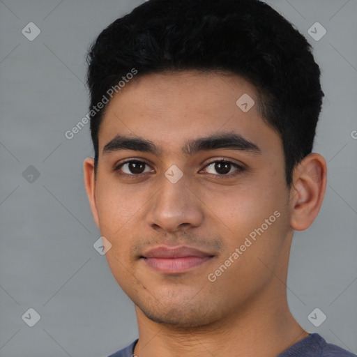 Joyful latino young-adult male with short  black hair and brown eyes