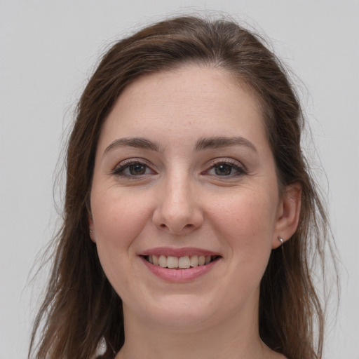 Joyful white young-adult female with long  brown hair and grey eyes