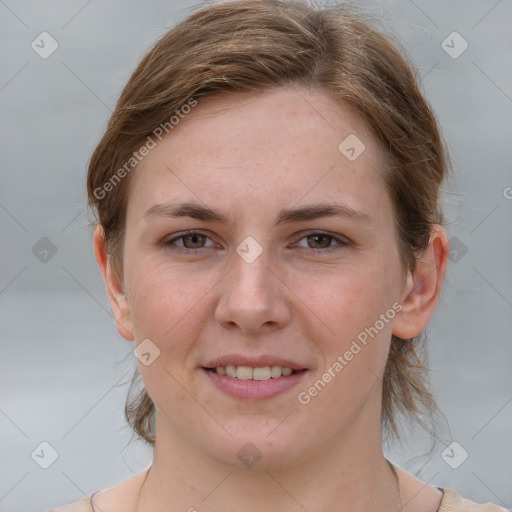 Joyful white young-adult female with medium  brown hair and grey eyes