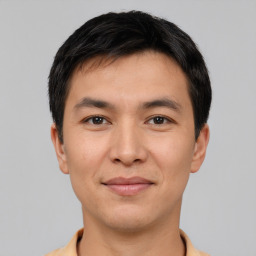 Joyful asian young-adult male with short  black hair and brown eyes