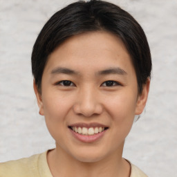 Joyful asian young-adult female with short  brown hair and brown eyes