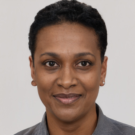 Joyful black adult female with short  black hair and brown eyes