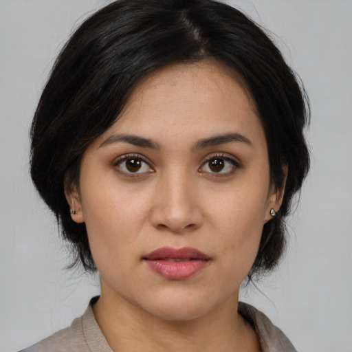 Joyful white young-adult female with medium  black hair and brown eyes