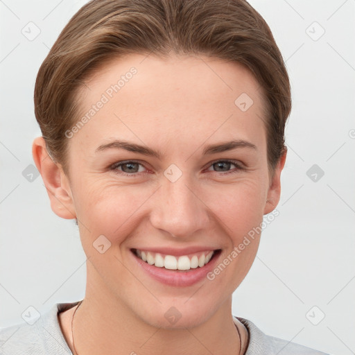 Joyful white young-adult female with short  brown hair and grey eyes