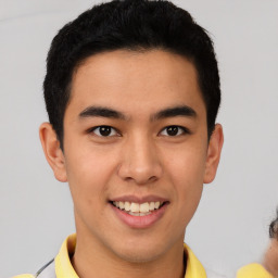 Joyful latino young-adult male with short  brown hair and brown eyes