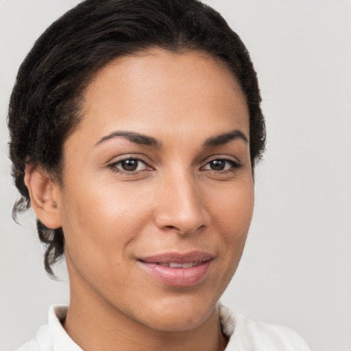 Joyful latino young-adult female with short  brown hair and brown eyes