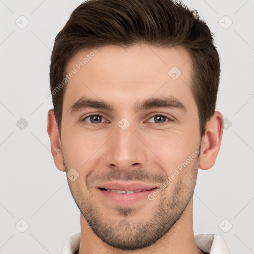 Joyful white young-adult male with short  brown hair and brown eyes