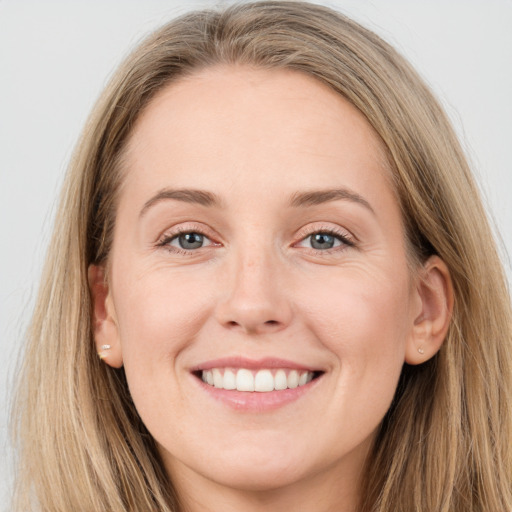 Joyful white young-adult female with long  brown hair and grey eyes