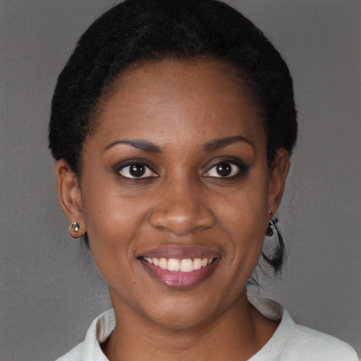 Joyful black young-adult female with short  brown hair and brown eyes