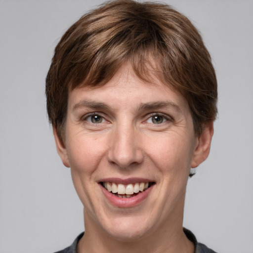 Joyful white adult female with short  brown hair and grey eyes