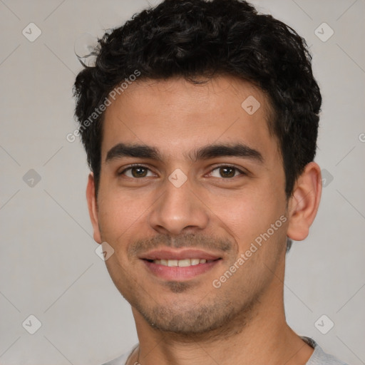 Joyful white young-adult male with short  black hair and brown eyes