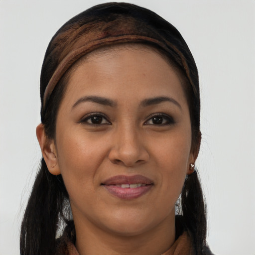 Joyful latino young-adult female with long  brown hair and brown eyes