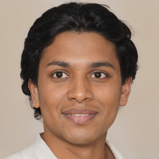 Joyful latino young-adult male with short  brown hair and brown eyes