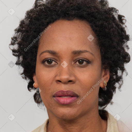 Joyful black adult female with short  brown hair and brown eyes