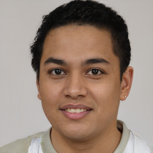 Joyful latino young-adult male with short  brown hair and brown eyes