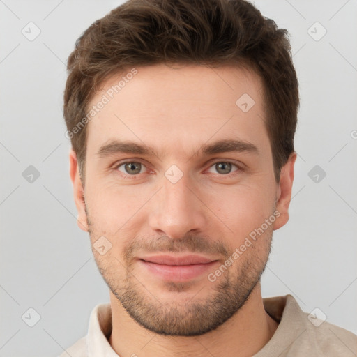 Joyful white young-adult male with short  brown hair and grey eyes