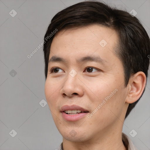 Joyful asian young-adult male with short  brown hair and brown eyes