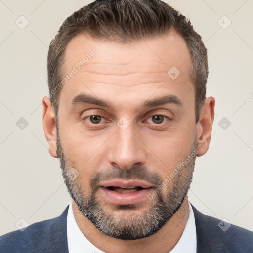 Joyful white adult male with short  brown hair and brown eyes