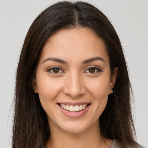 Joyful white young-adult female with long  brown hair and brown eyes