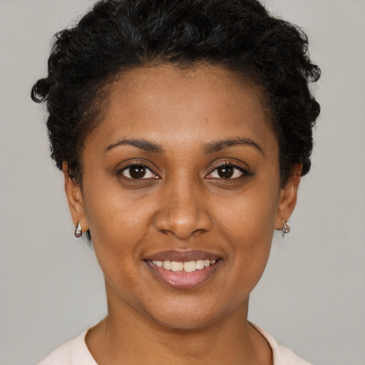 Joyful latino young-adult female with short  brown hair and brown eyes