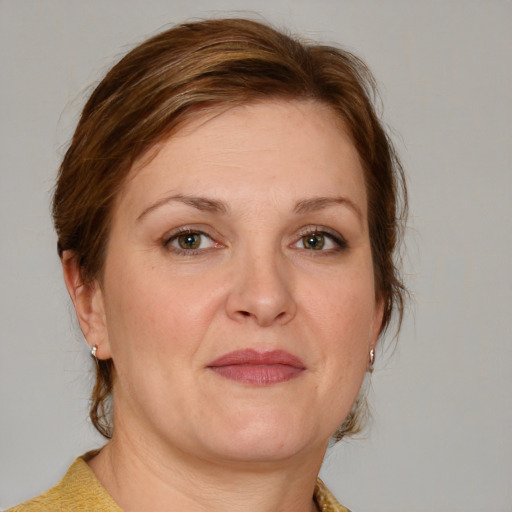 Joyful white adult female with medium  brown hair and blue eyes