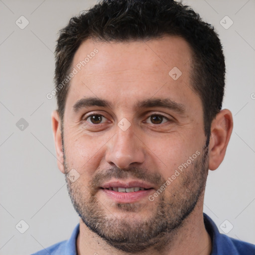 Joyful white adult male with short  black hair and brown eyes