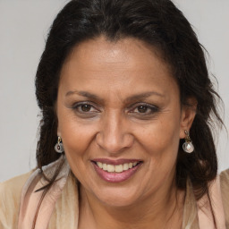 Joyful latino adult female with medium  brown hair and brown eyes