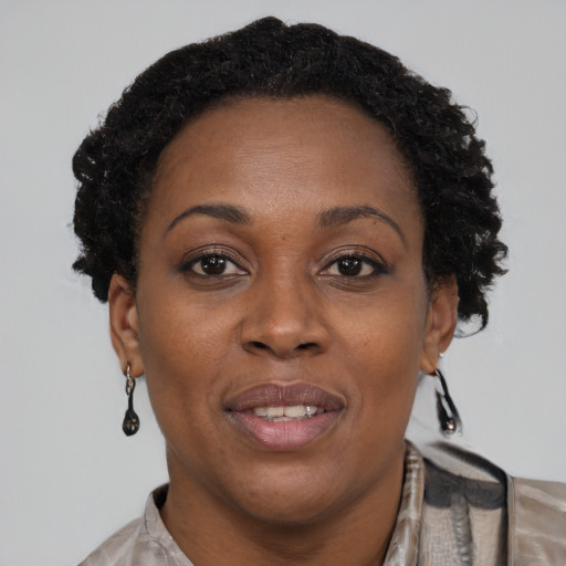 Joyful black adult female with short  brown hair and brown eyes