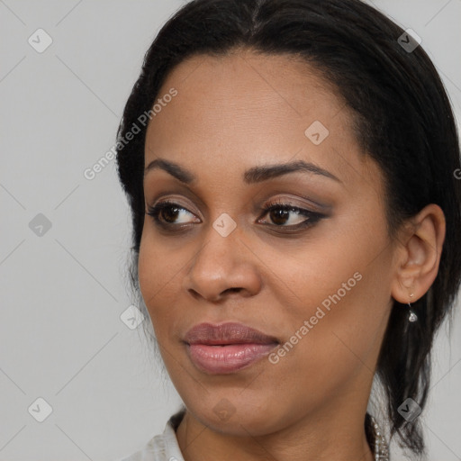 Joyful black young-adult female with medium  black hair and brown eyes