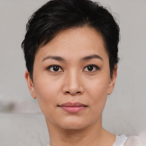 Joyful asian young-adult female with short  black hair and brown eyes