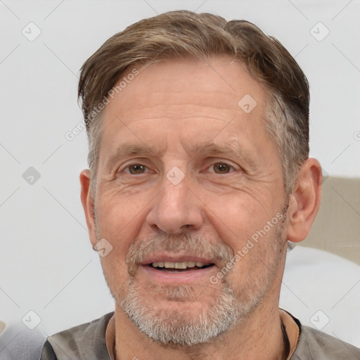 Joyful white middle-aged male with short  brown hair and brown eyes