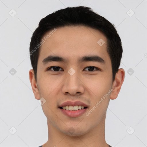 Joyful asian young-adult male with short  black hair and brown eyes