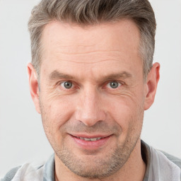 Joyful white adult male with short  brown hair and grey eyes