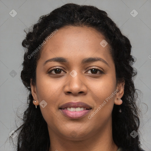 Joyful black young-adult female with long  brown hair and brown eyes