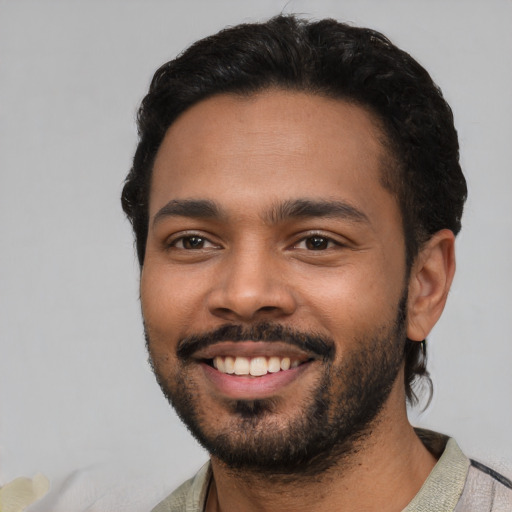 Joyful latino young-adult male with short  black hair and brown eyes